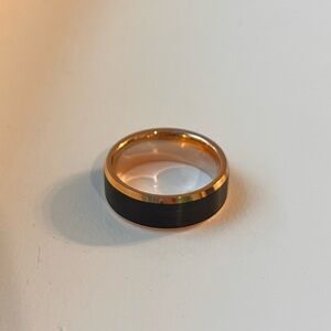 Men’s black and rose gold wedding band
